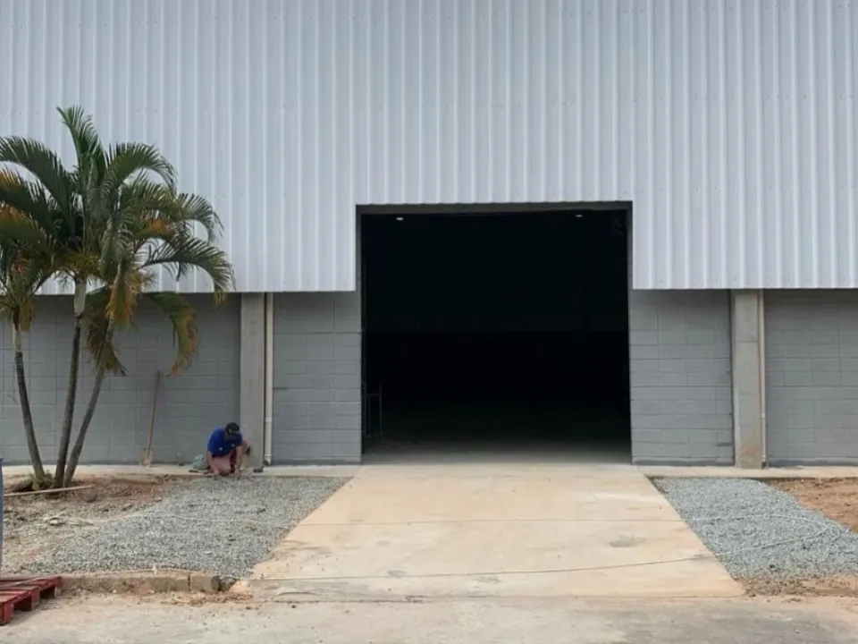 Galpão industrial concluído com fechamento metálico e portão aberto